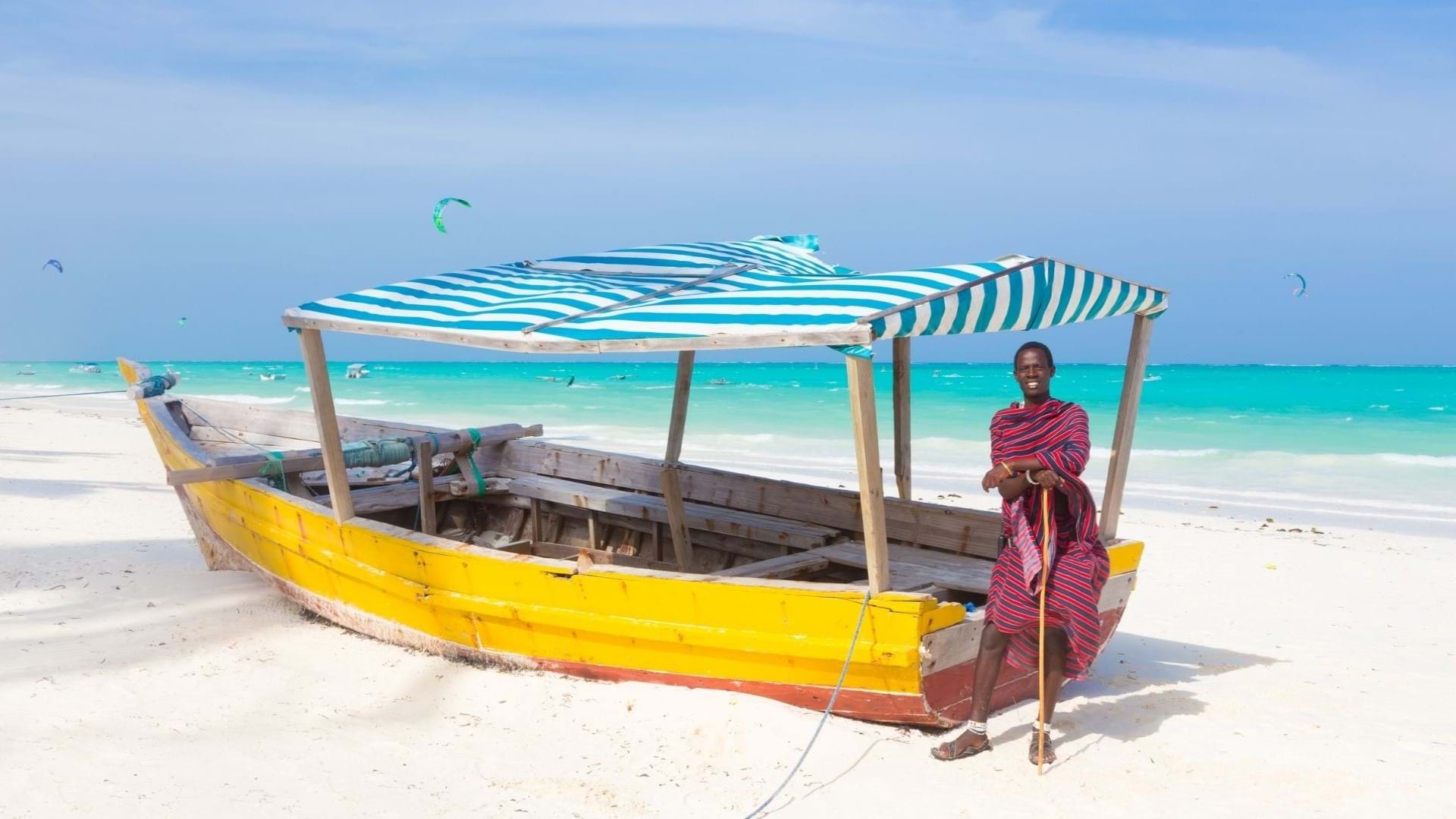 Zanzibar Putovanje - plaža i lokalni ribar  na plaži. U pozadini tirkizno more i beli pesak